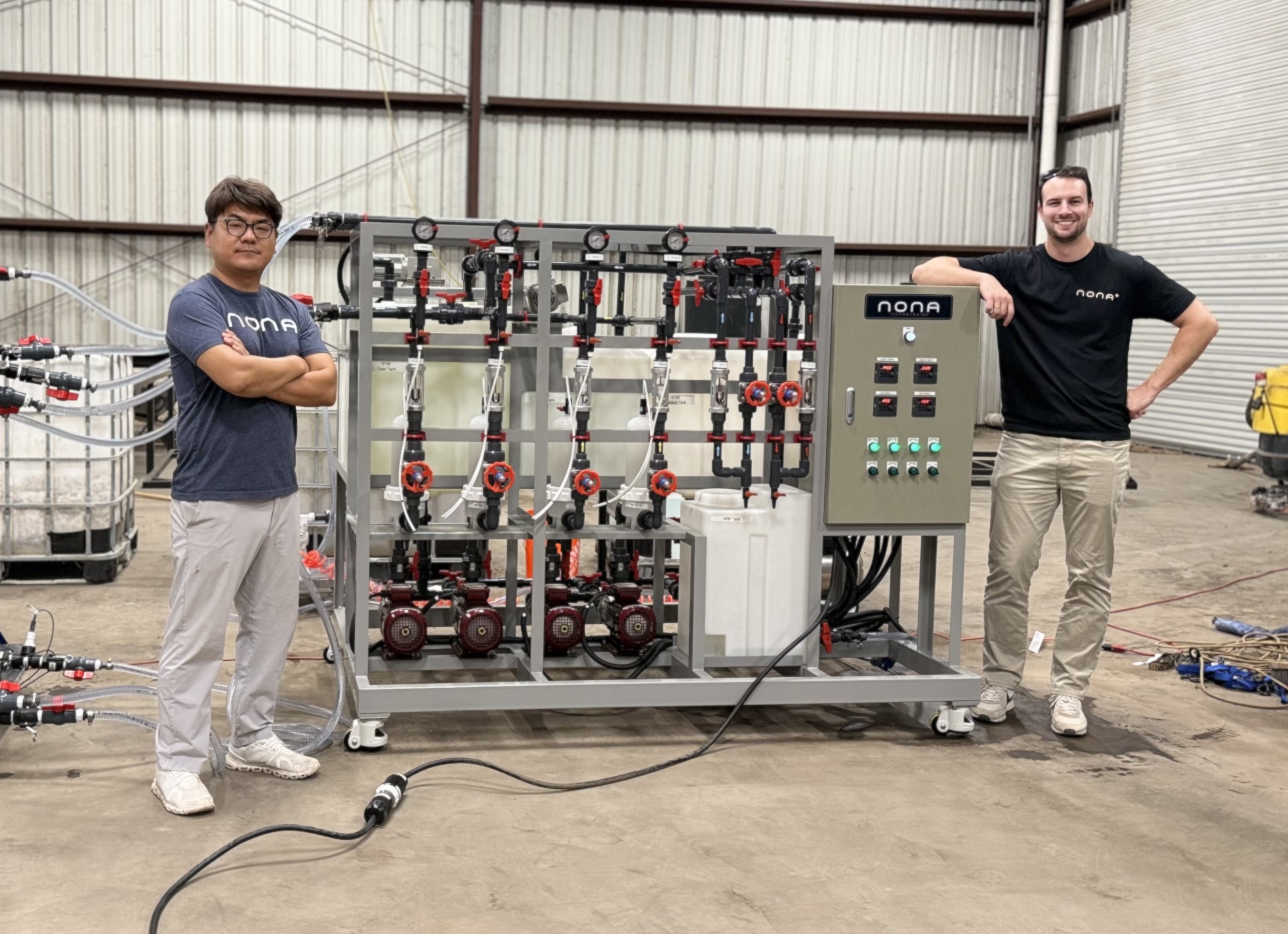 Nona founders Bruce Crawford and Jung Yoon standing with the full RECOVER unit at Tracy Renewable Energy